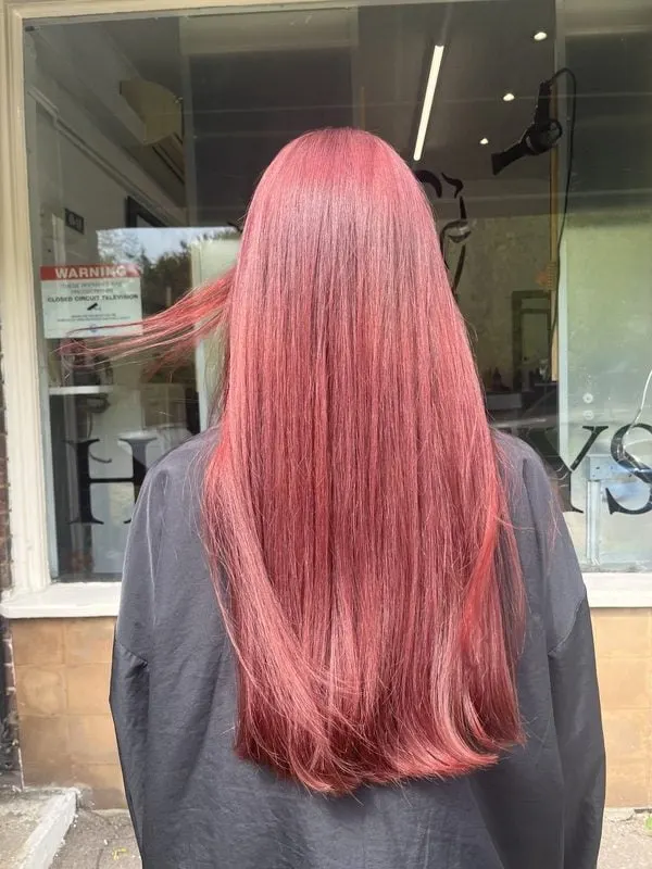 Long rose pink hair colour outside Harvey's Hairdressers salon in Luton
